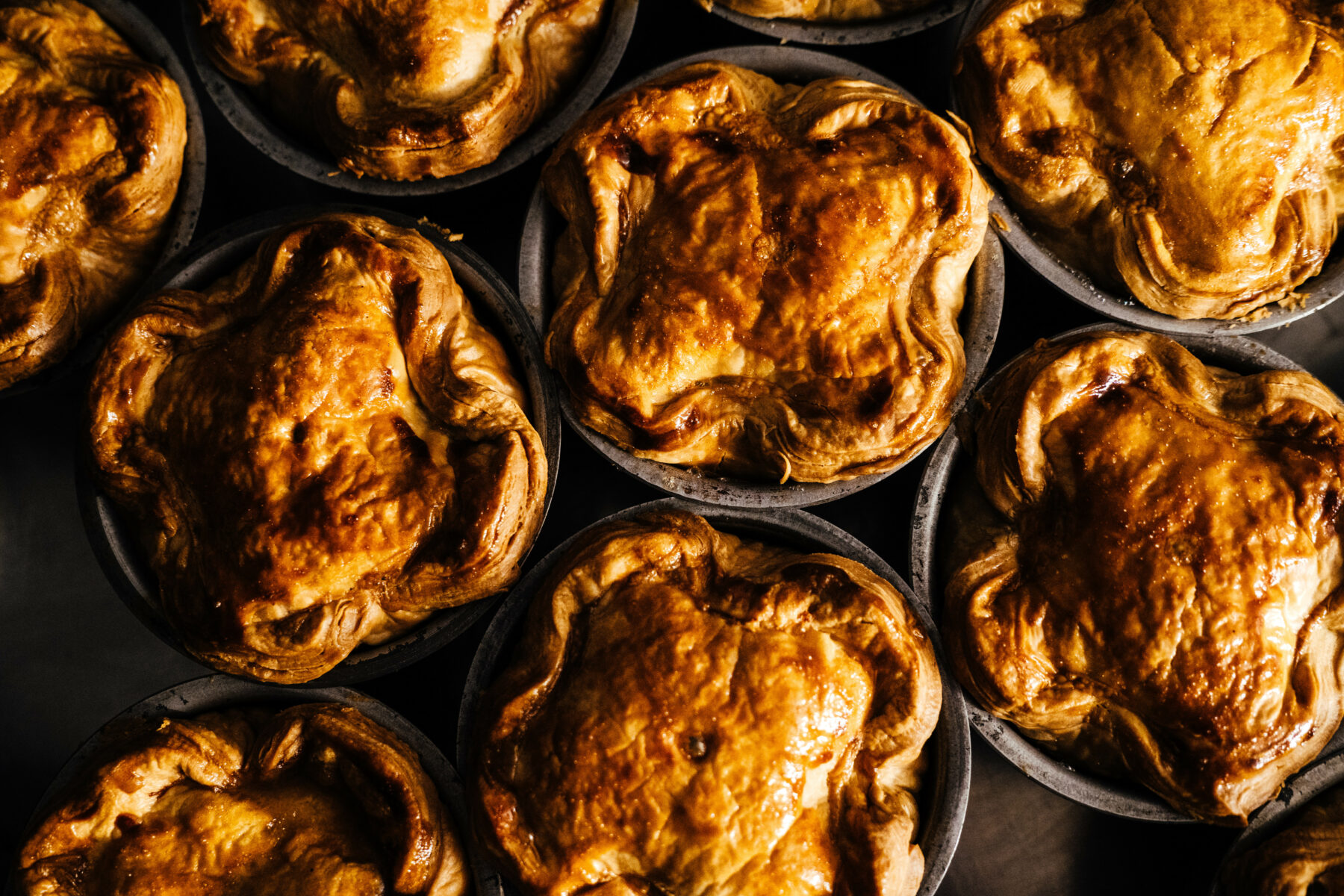 Golden brown pies in bakign tins
