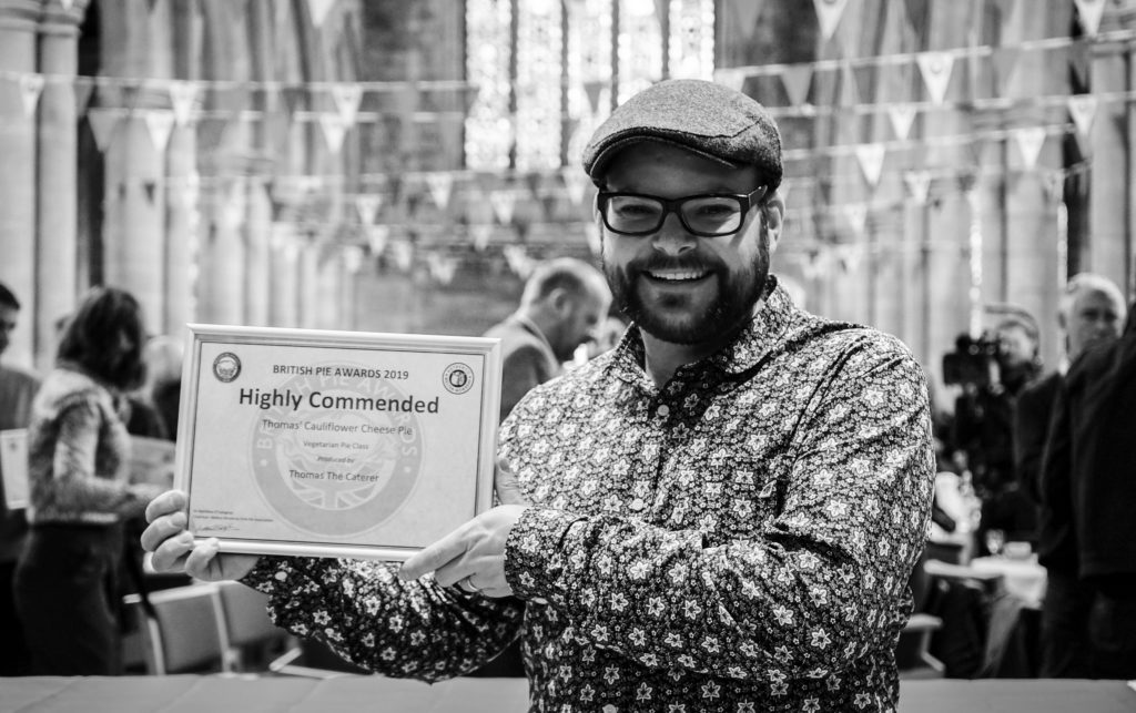 Thomas the caterer at the British Pie Awards holding his award for his cauliflower cheese pie