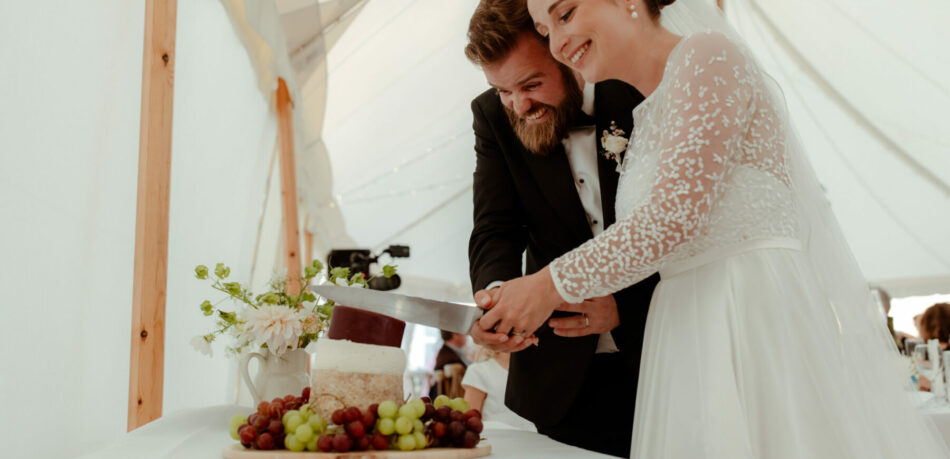 Bride And Groom Cutting The Wedding Cheese Cake