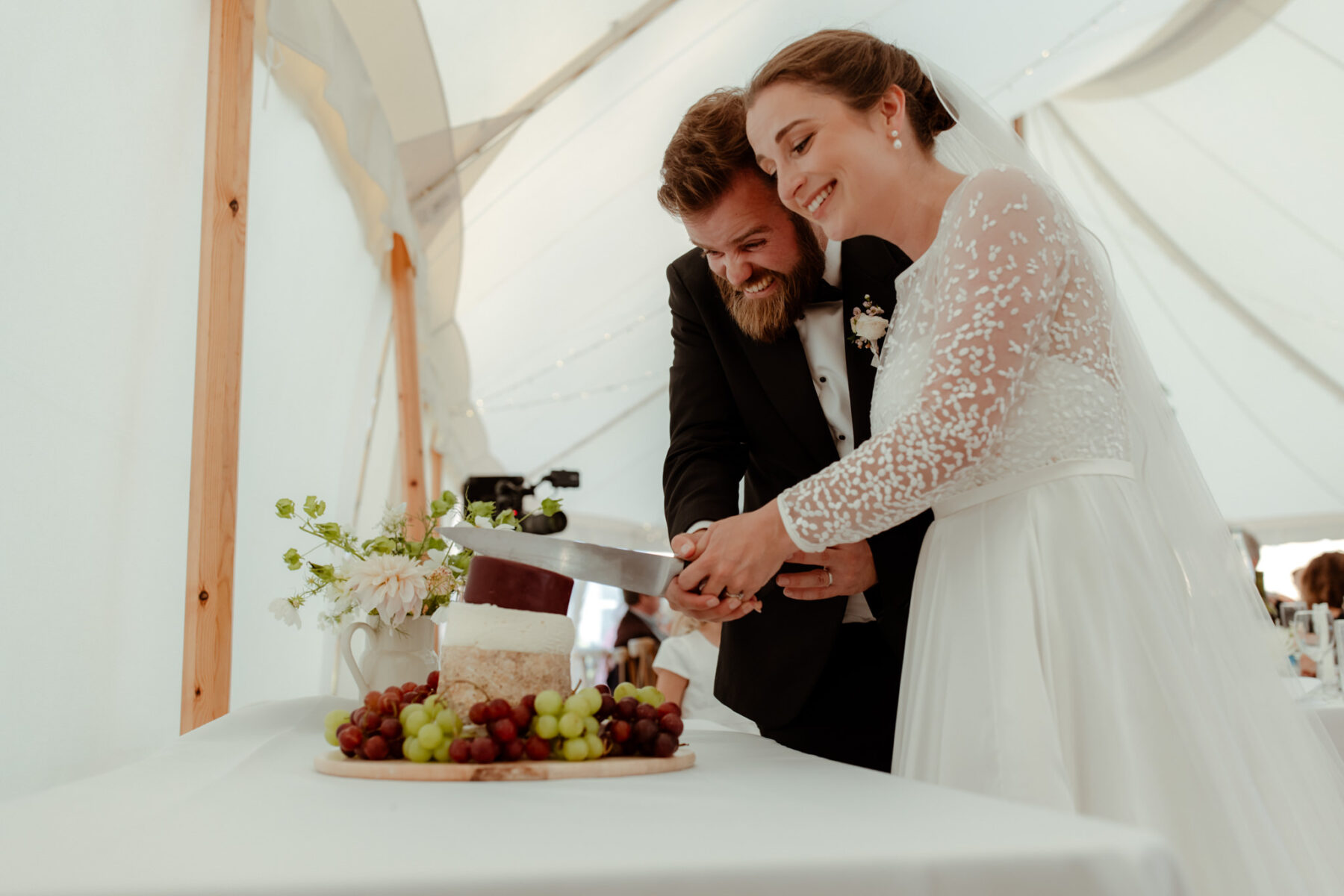 Bride And Groom Cutting The Wedding Cheese Cake
