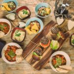 Evening Food Platter Consisting Of Burgers, Chilli Con Carne And More